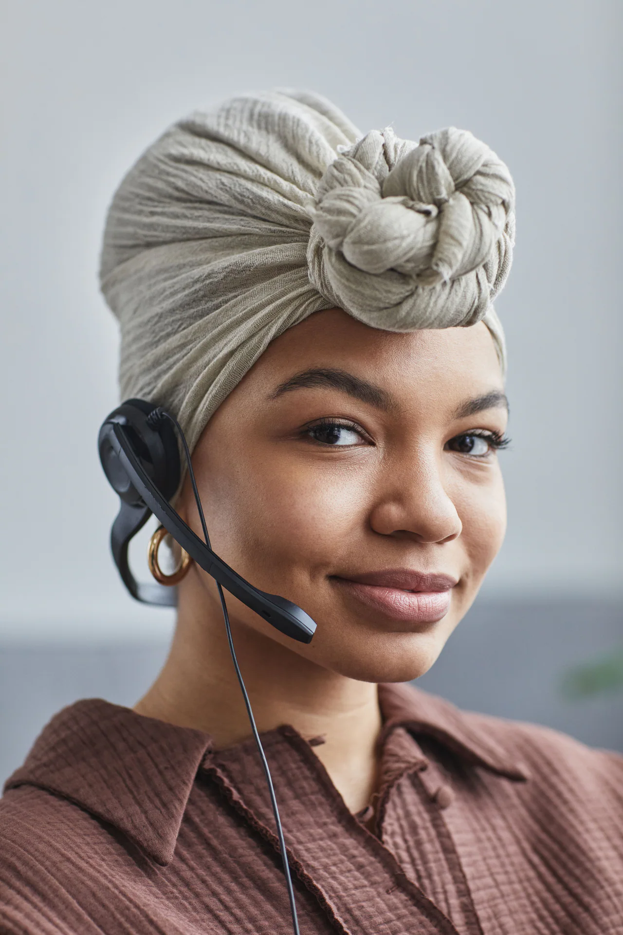 Smiling Black customer support agent wearing a headset