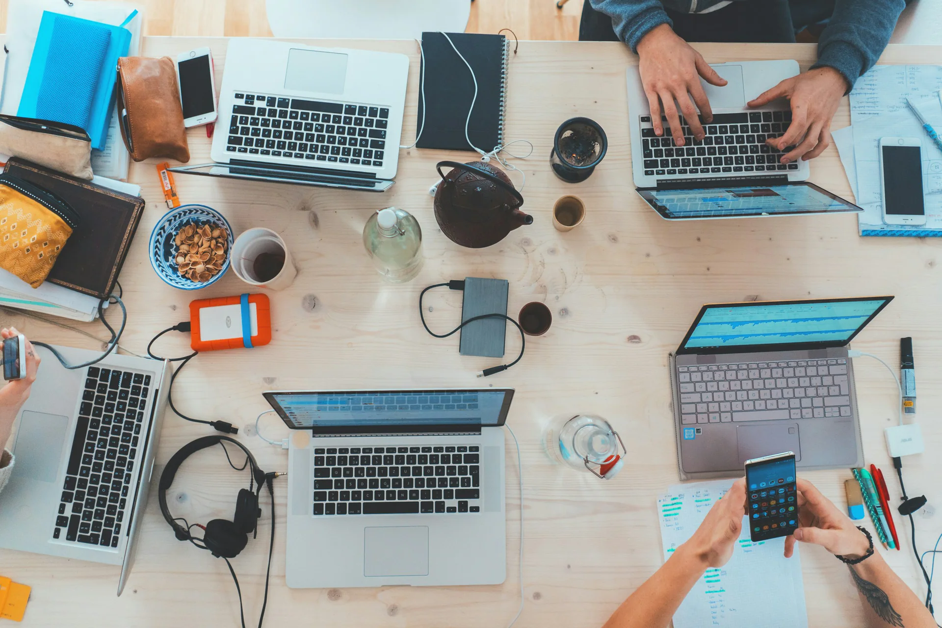 Technology team workspace with laptops and devices