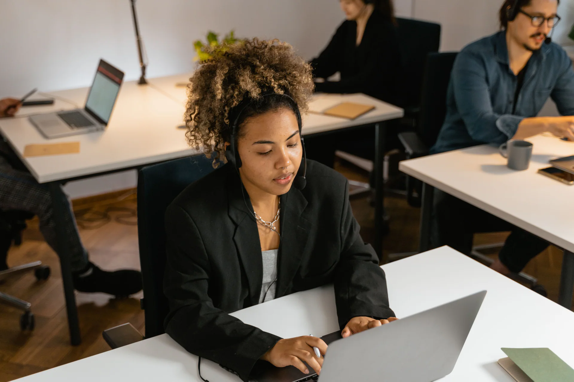 Support agent managing service requests at a laptop