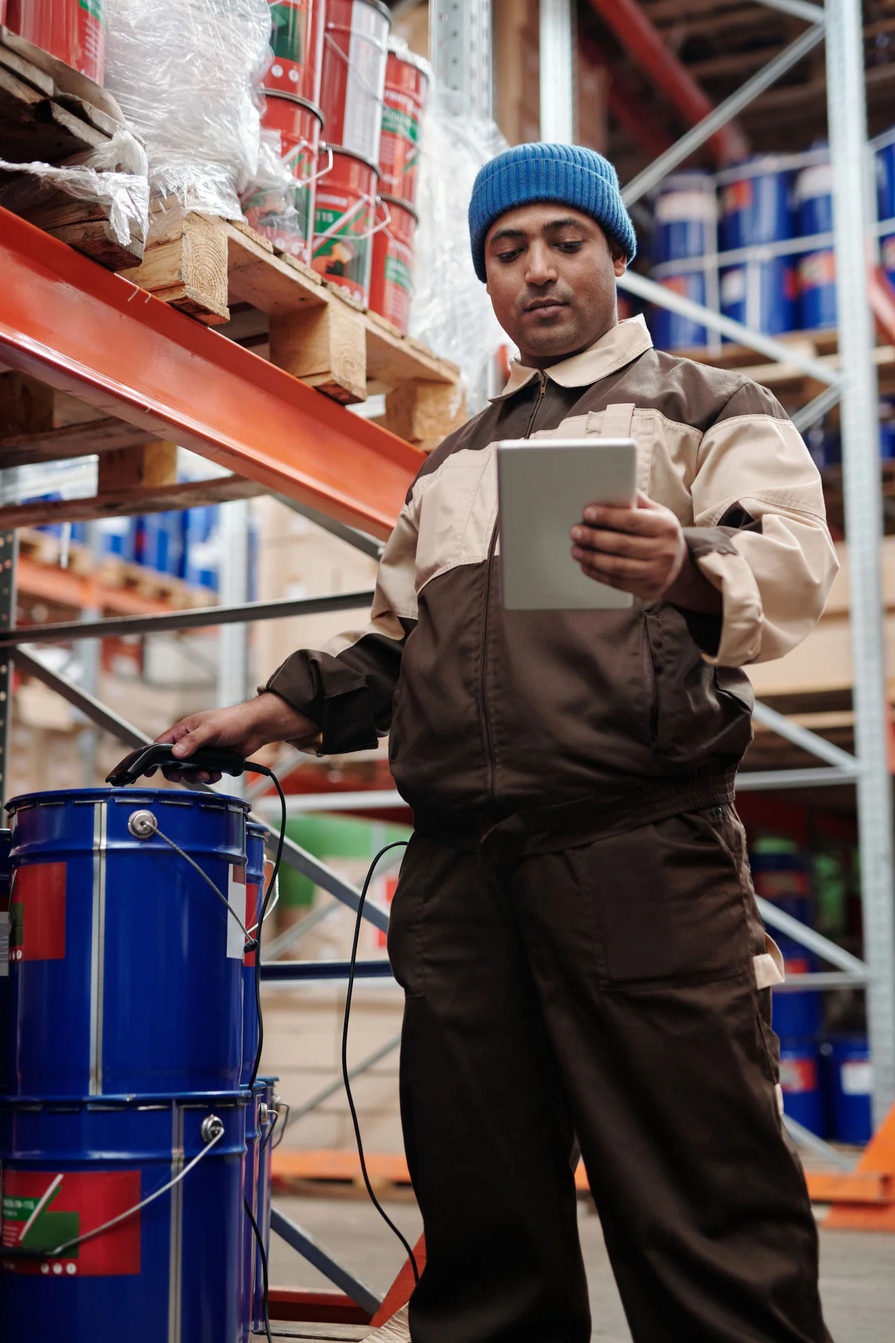 Black logistics professional using a tablet in a warehouse