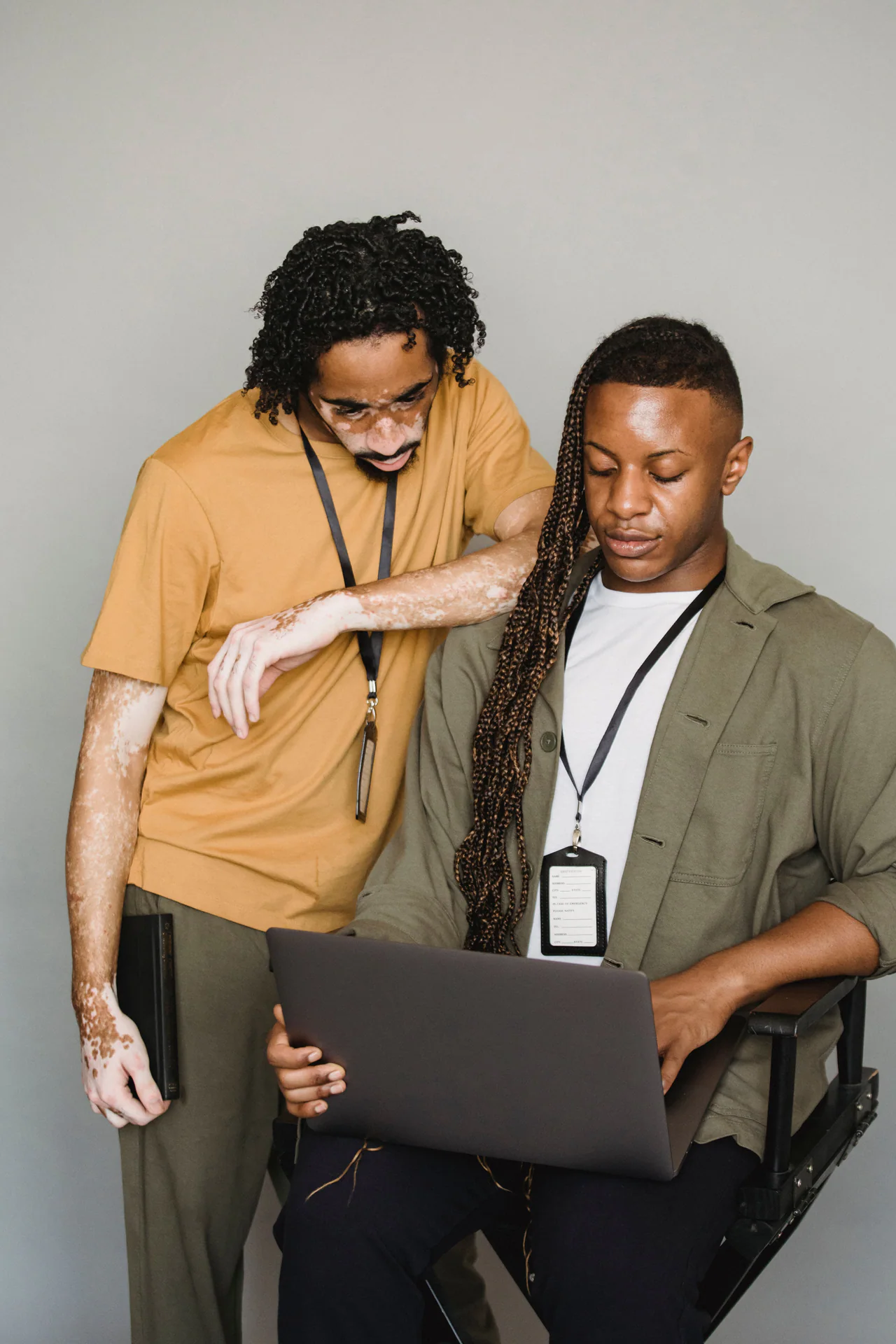 Black technology professionals reviewing a workflow together on a laptop