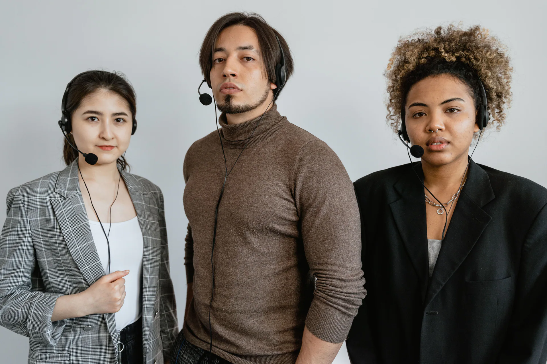 Diverse support team standing together with headsets